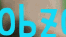 a close up of the word zoo in blue letters on a blurry background .