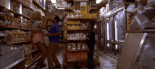 a man and a woman are standing in a grocery store in front of a sign that says ' expires all day '