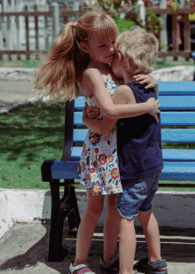 a little girl kissing a boy on the cheek