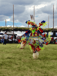 a man in a colorful native american costume has the number 700 on his waistband