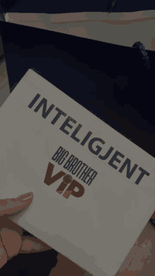 a person is holding an envelope that says " intelligent big brother vip "