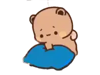 a cartoon bear sitting on a blue pillow