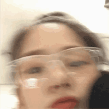 a blurry picture of a woman wearing glasses .