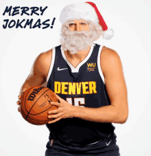 a denver basketball player wearing a santa hat and holding a basketball