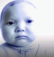 a baby 's face is shown with a serious look on his face