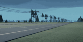 a black car is driving down a road with trees and power lines in the background