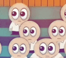 a group of cartoon characters with big eyes are sitting next to each other on a couch .