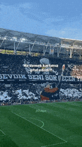 a soccer field with a banner that says " sevdik seni sor "