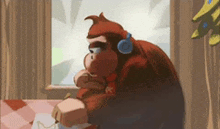 a monkey wearing headphones is sitting in front of a window .