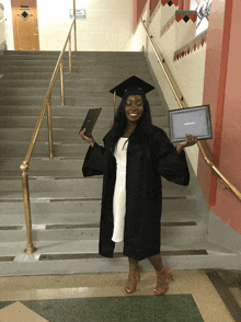 a woman in a graduation cap and gown is holding a diploma that says masters