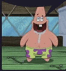 patrick star from spongebob squarepants is standing on a wooden floor with a balloon in his mouth .