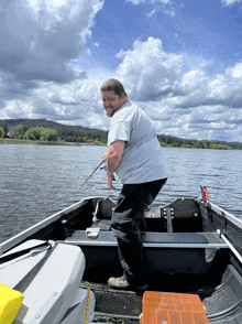 a man in a boat with a fishing rod in his hands