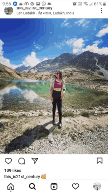 a woman stands in front of a lake with mountains in the background and the caption this is 21st century