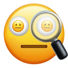 a magnifying glass is looking at an emoji face