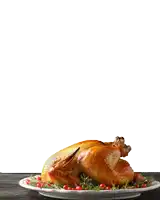 a turkey is standing on a plate with tomatoes and greens