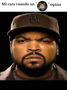 ice cube wearing a la hat with a picture of a cat behind him