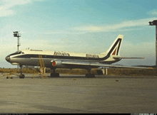 an airitalia plane is parked on the tarmac at an airport