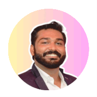 a man with a beard is smiling in front of a pink circle