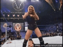 a woman is dancing in a wrestling ring with the words make gifs at gifsoup.com below her