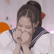 a girl with a ponytail and a sailor uniform covering her mouth with her hands