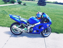 a blue kawasaki motorcycle with a helmet on it