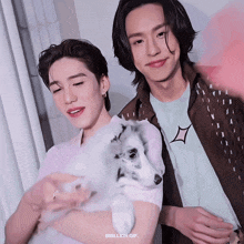 a gif of two men holding a dog with the words bbillkin gif on the bottom right