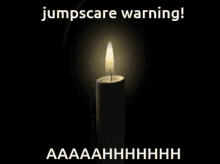 a picture of a lit candle with the words jumpscare warning written above it