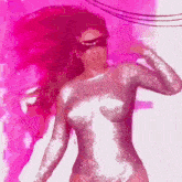 a woman wearing a mask and sunglasses is dancing in a pink room .