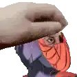 a hand is covering a person 's face with a purple and orange scarf .