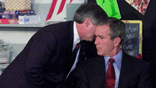 two men are kissing in front of a chalkboard that says reading makes a country gift