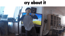 a boy is dancing in front of a tv with the words cry about it below him