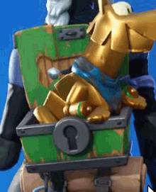 a statue of scooby doo is sitting inside of a green treasure chest .