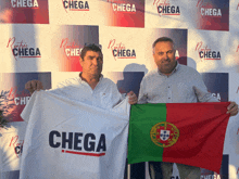 two men holding up a flag that says chega