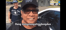 a man wearing sunglasses and a hat that says dung