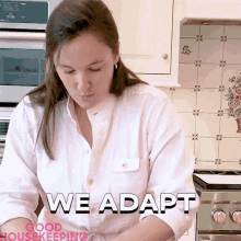 a woman in a white shirt is standing in a kitchen with the words " we adapt " above her