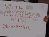 a person holding up a sign that says " will do anything for $ 30 "