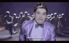 a man in a purple suit with a crown on his head says " i gave them candy "