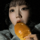a close up of a woman eating a hamburger