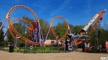 a roller coaster is sitting in the middle of a park .