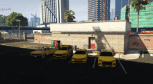 a group of yellow cars are parked in front of a building