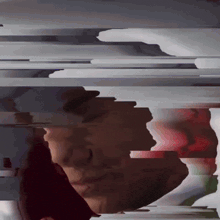 a blurred image of a person 's face with a red and white border