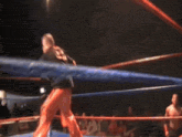 a blurry picture of two boxers in a boxing ring with a blue rope