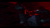 a blurred image of a person holding a gun