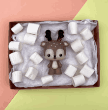 a box filled with marshmallows and a toy deer