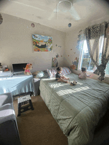 two children sit on a bed in a bedroom