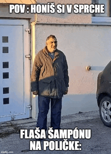 a man in a jacket is standing in front of a garage door with a car parked in front of him ..