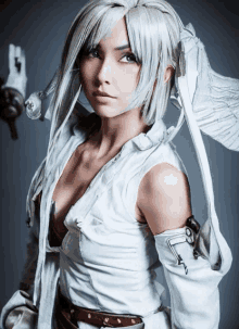 a woman in a white costume with wings and a sword looks at the camera