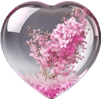 a heart shaped container with pink flowers inside of it