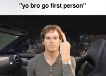 a man sitting in a car giving the middle finger
