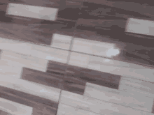 a close up of a wooden floor with a diagonal pattern